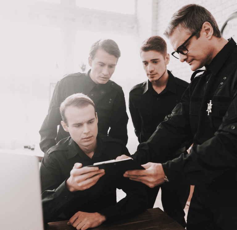 Corrections Officers reviewing data on a clipboard
