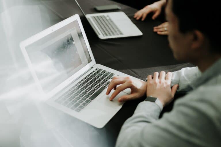 A man on a laptop in a conference room