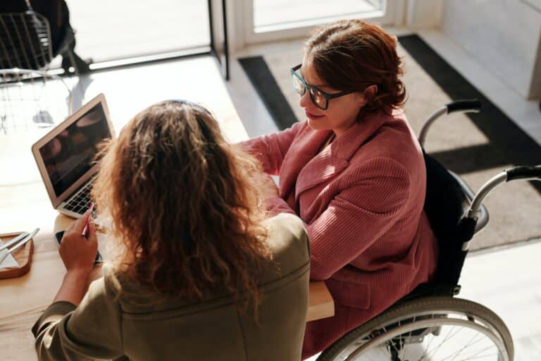 Two women researching on a laptop