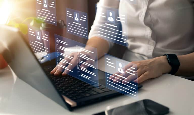 Businessman on a laptop viewing personal information of several people