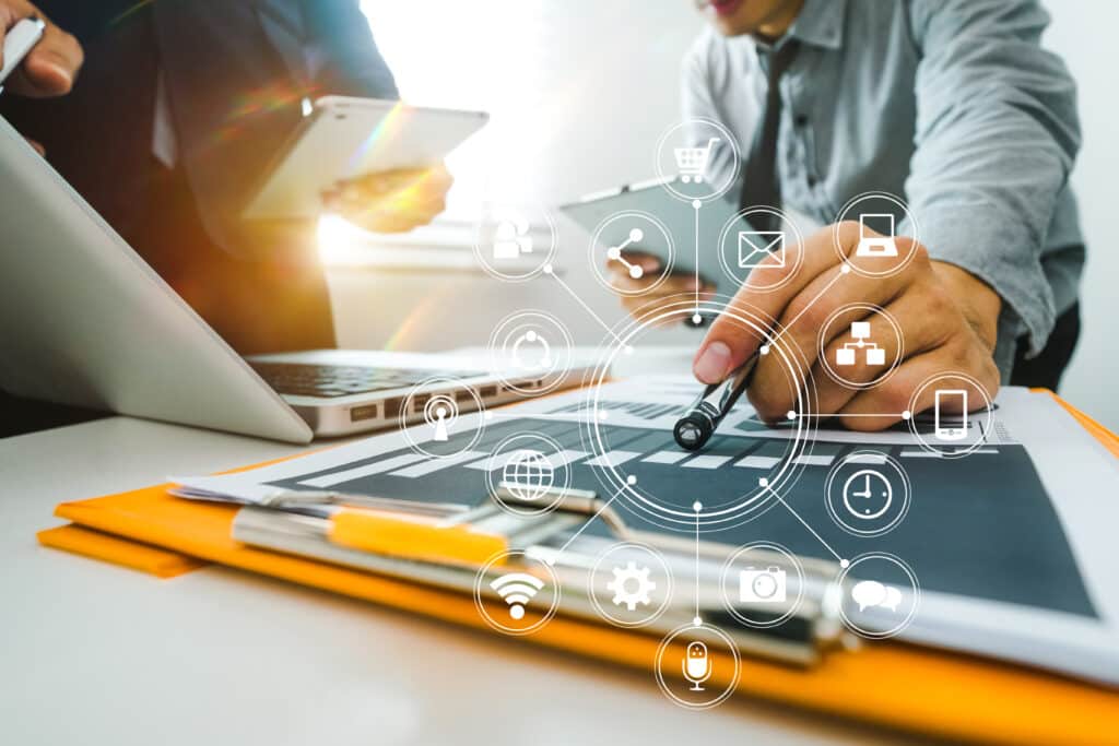 Team business meeting presentation. Hand businessman working project in modern office.Laptop computer and tablet and smart phone on white desk in morning light