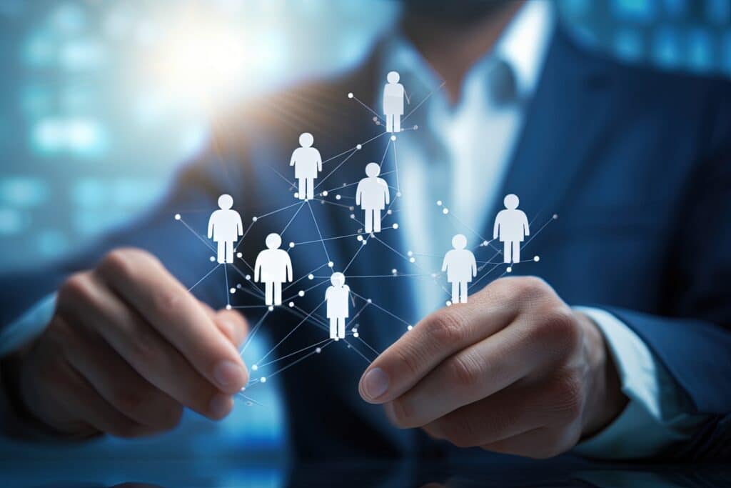 A rendering of a digital network of people being held in the hands of a businessman
